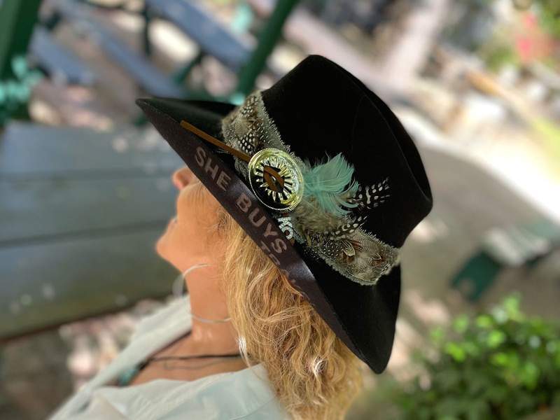Blond woman viewed from the side wearing a custom hat with personalized branding and decor from Weld and Wool.