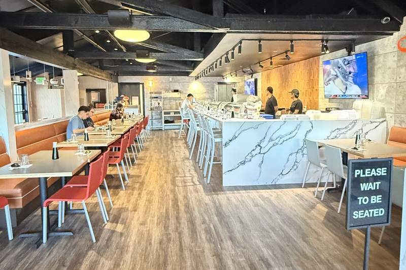 Several people dine at tables and the sushi bar at Fire Fish Sushi and More.