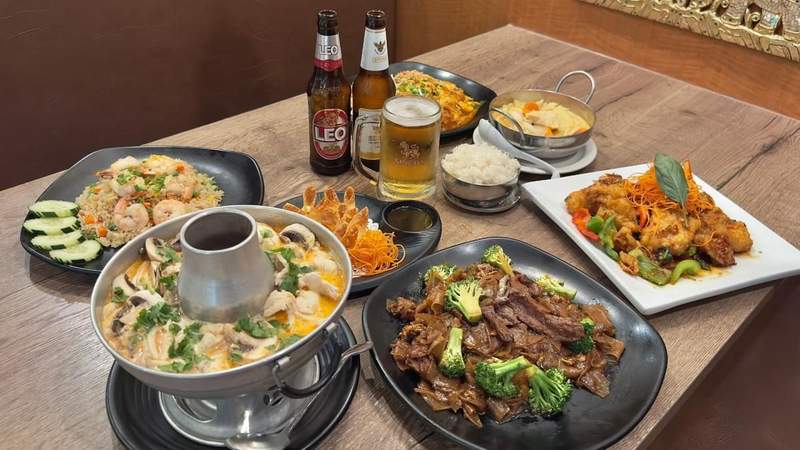 A spread of various menu items are accompanied by cold beers at S Thai in Temecula.