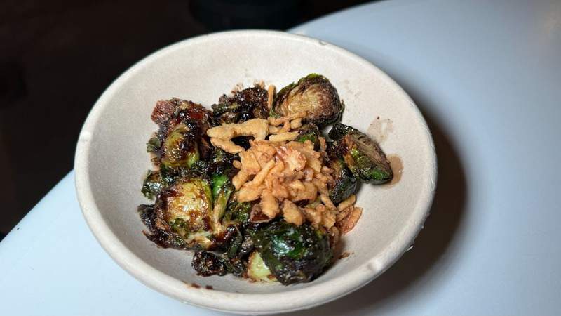 Paper bowl filled with green brussels sprouts 