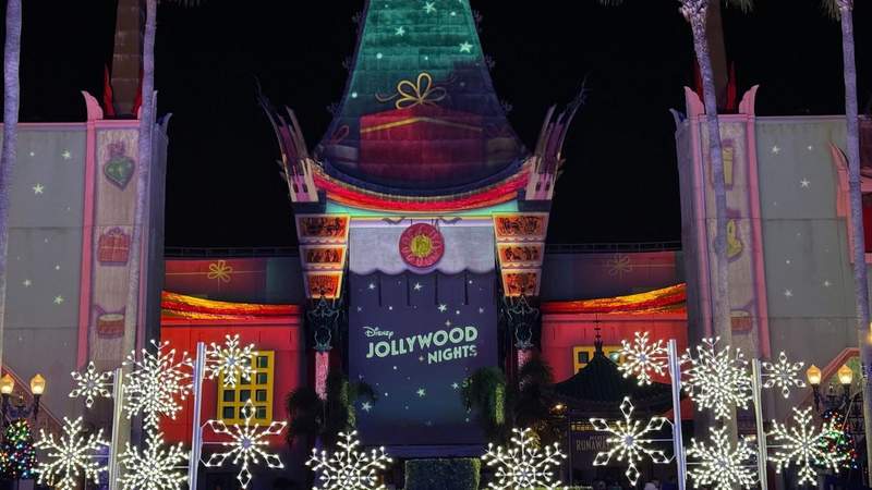 A Disney Jollywood Nights sign surrounded by snowflakes. 