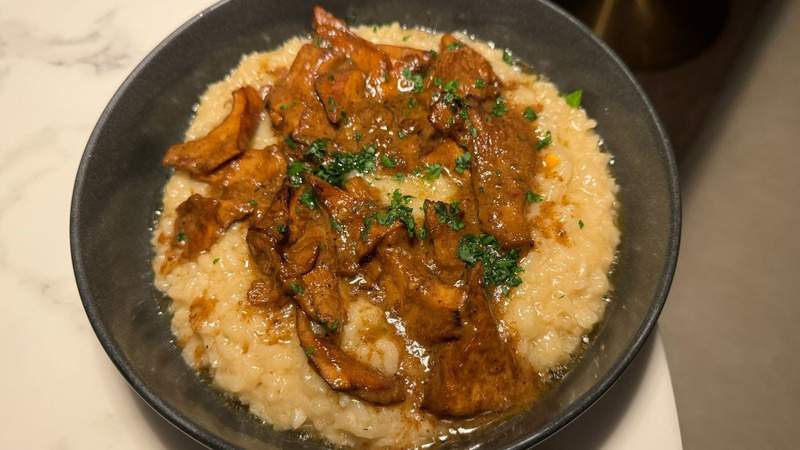 grey bowl of risotto and mushrooms with green cilantro from a Solvang restaurant. 