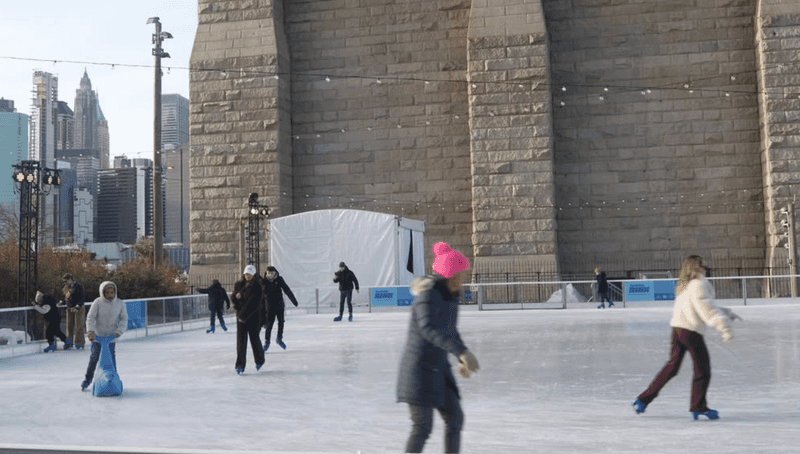 Ice skating under the Brooklyn Bridge.