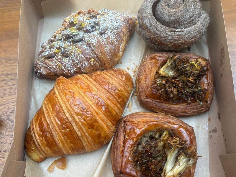 Pastry assortment including the pistachio croisssant, top left, and cardamom bun, top right