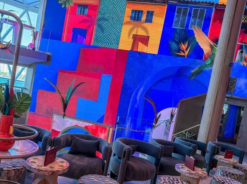 lounge tables with colorful wall backdrop