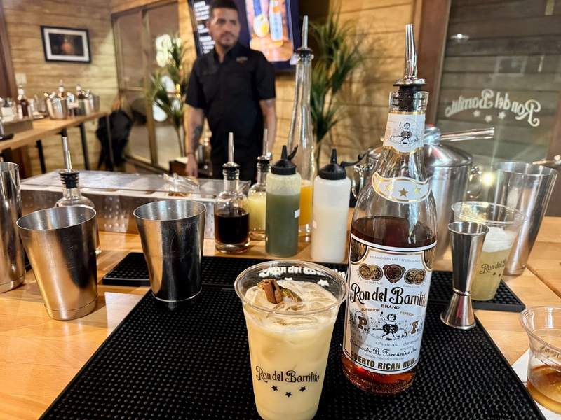A cocktail next to a bottle of Ron del Barrilito rum