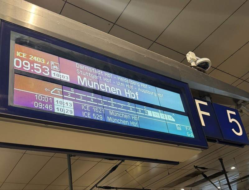 An overhead train timetable display at Frankfort Airport.