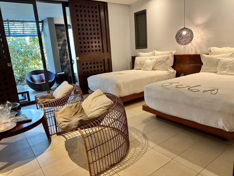 Garden suite with two queen beds and BULA spelled out in shell necklaces at Intercontinental Golf Resort and Spa.