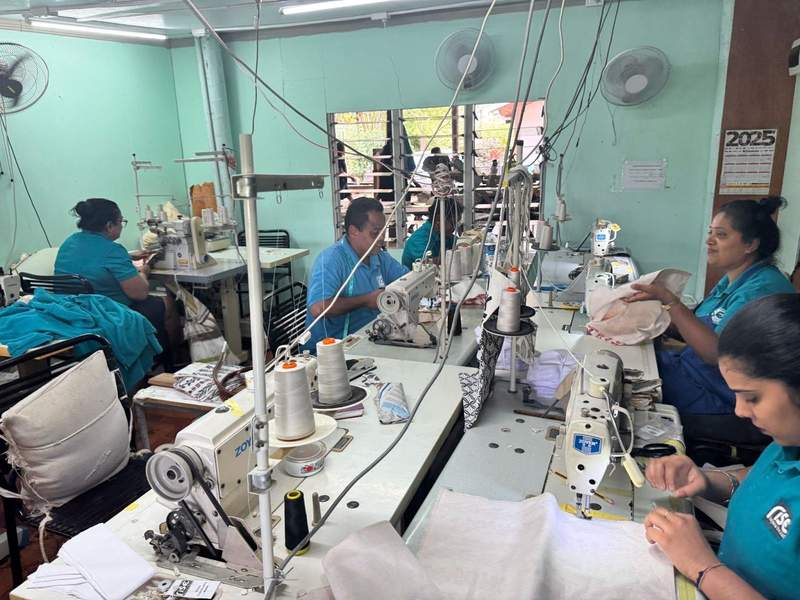 Rise Beyond the Reef sewing experts creating bags for sale.