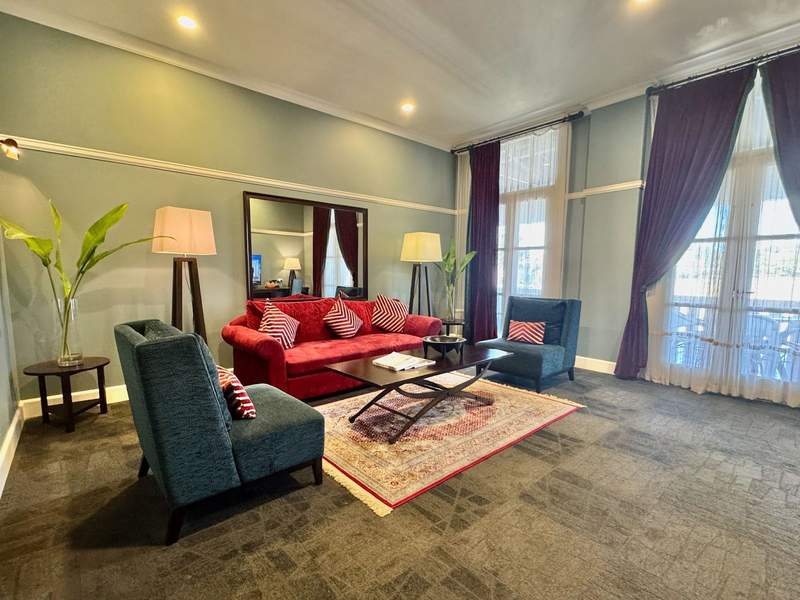 Huge living room with red sofa in my suite at the Grand Pacific Hotel in Suva Fiji.