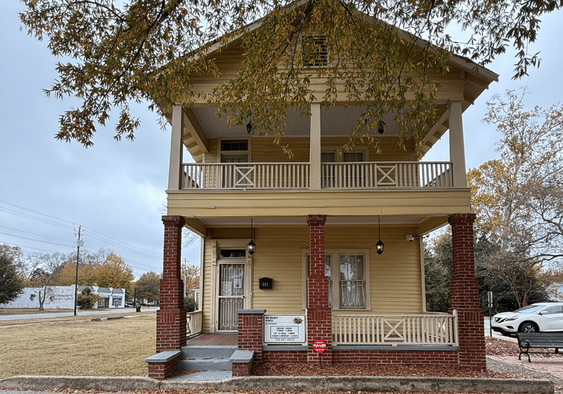 Front view of two-story house with brick columns.