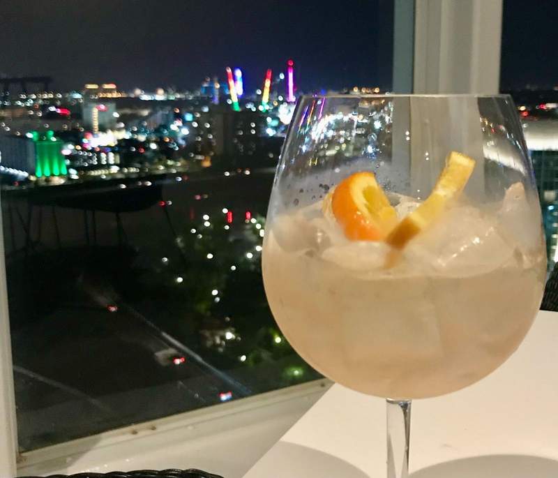 cocktail in front of nighttime cityscape