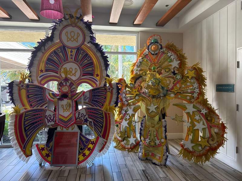 The image shows two very colorful costumes worn during the Bahamian Junkanoo Festival. These are in the lobby of the Warwick Paradise Island