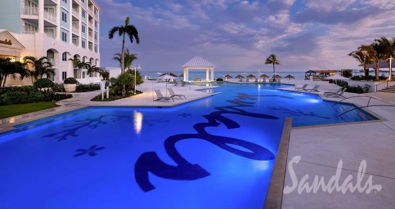 The photo is of the large pool at the Sandals Royal Bahamian Resort. Blue water with Sandals in the bottom of the pool.
