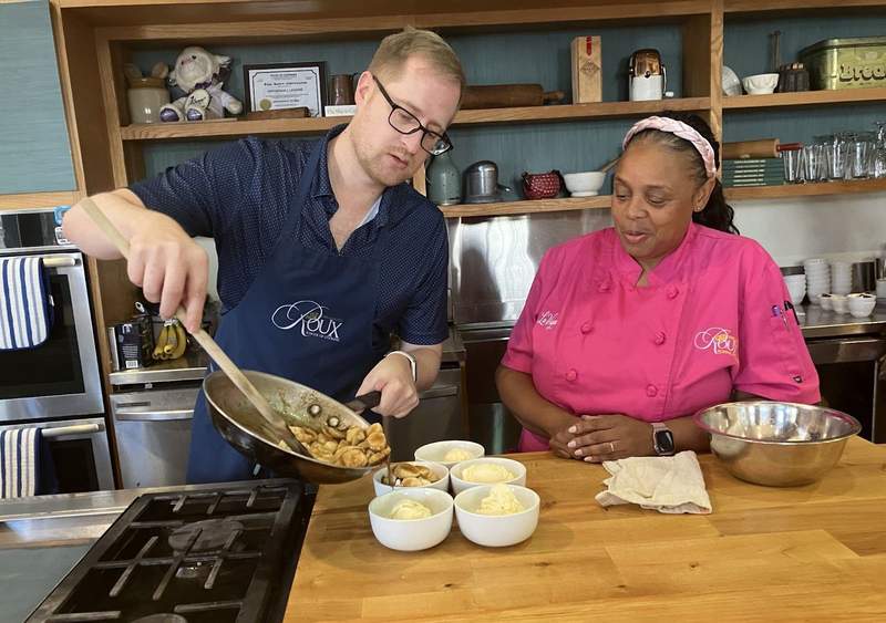 Chef teaching a participant how to make bananas foster.