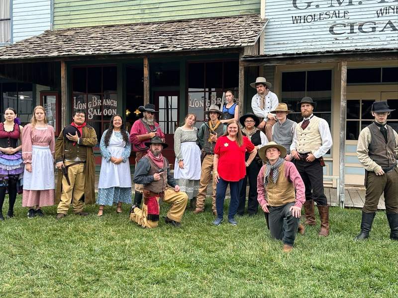 Group of people in front of the Long Branch Saloon at the Boot Hill Museum in Dodge City on the Kansas Gunsmoke Trail. 