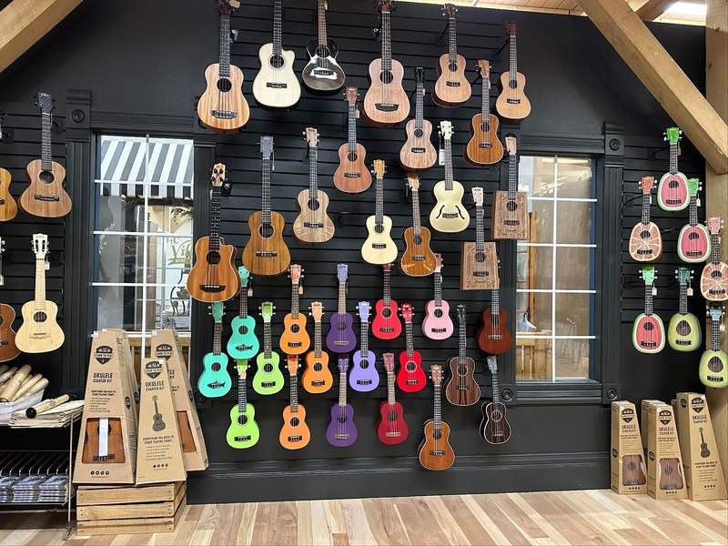Colorful guitars hanging on a wall.