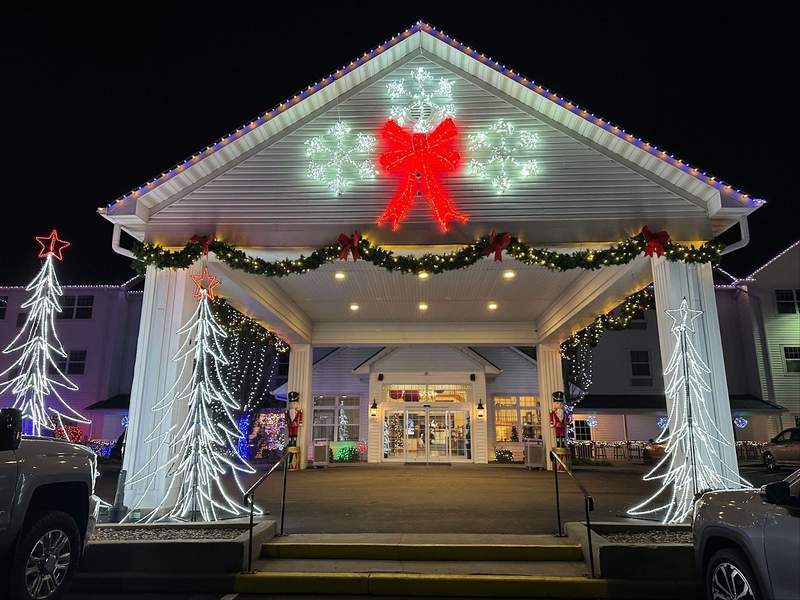 The entrance of a building with garland and other Christmas decorations.