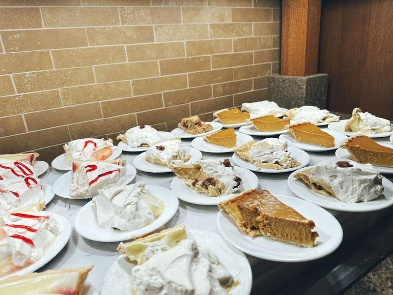 A table with twenty pieces of pie on it. 