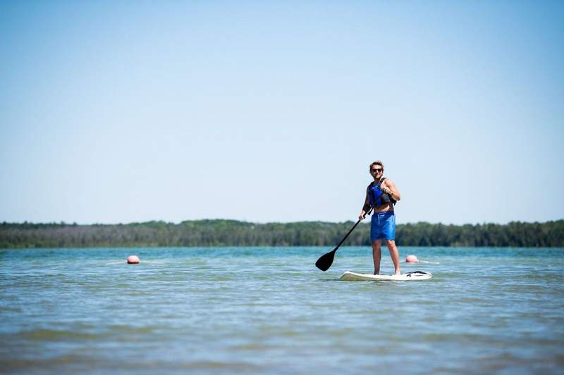 Man on stand up paddle board in a lake