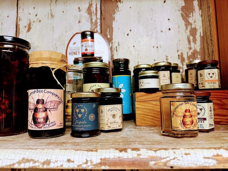 Bottles of honey on a shelf.