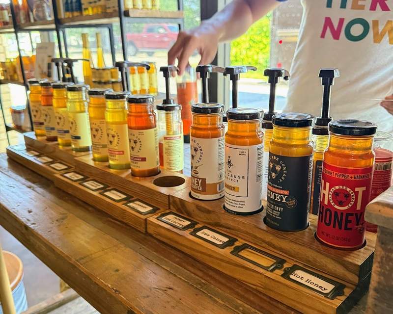 A line of different honey varietals at Savannah Bee Company's storefront.