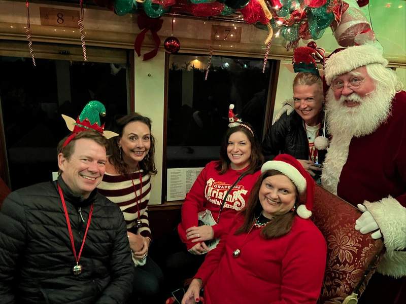 A group of people with Santa Claus.