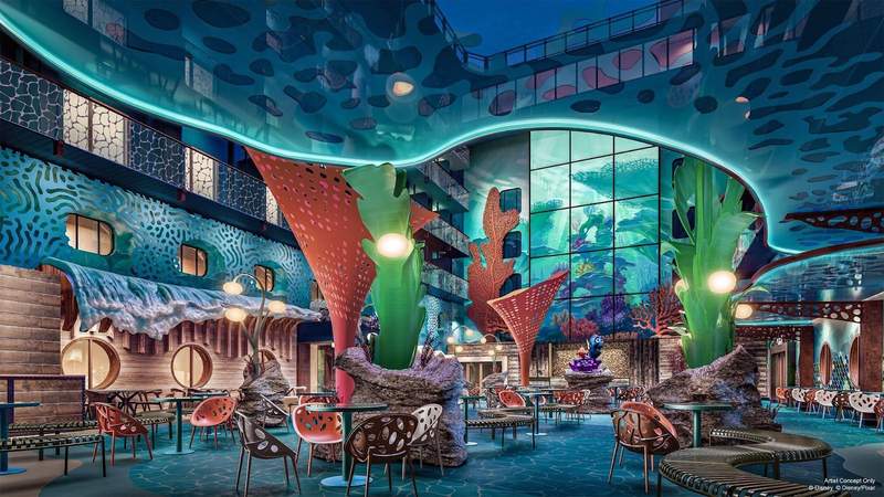 An underwater themed open air dining and shopping area featuring cafe style dining tables and chairs with aqua blue green and coral decor. 