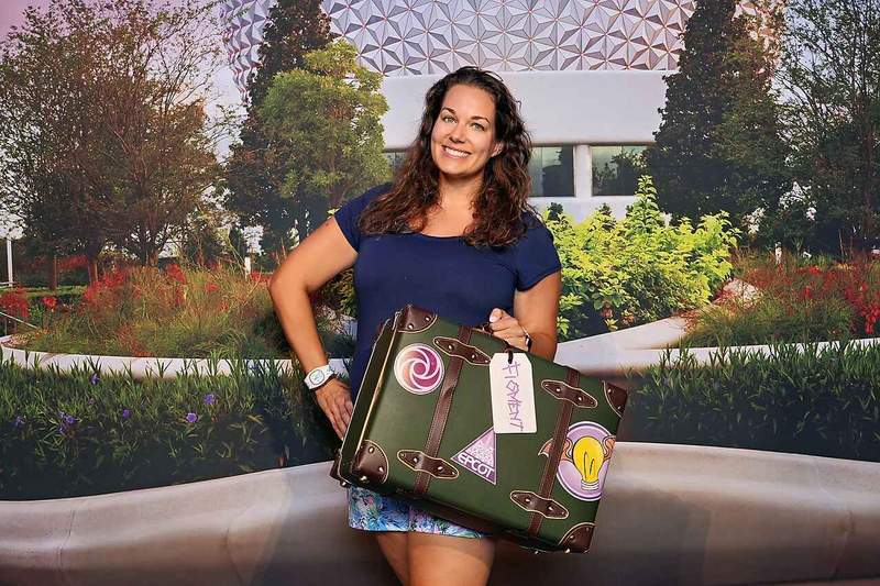 Disney Photopass photo for Epcot International Food and Wine Festival. woman holding suitcase.