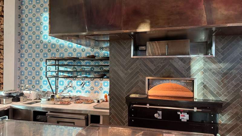 Metal fireplace next to an open kitchen. 