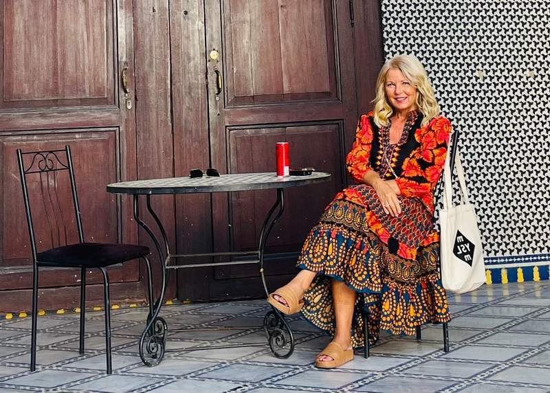 A woman experiencing hospitality at a historic riad that was once a palace in Fes Morocco