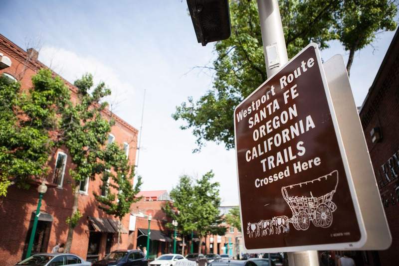 A sign shows the intersection of the Santa Fe Oregon and California Trails all which intersect in Kansas City.