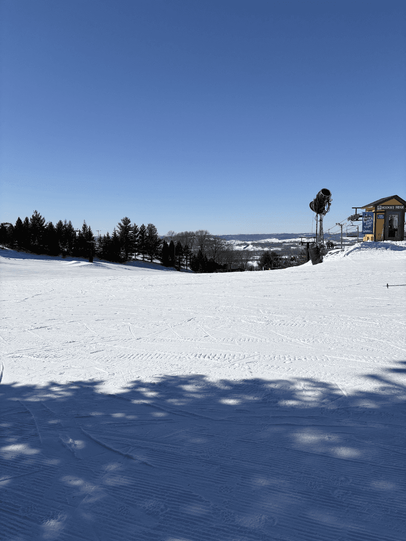 Flat snowy area with ski lift 