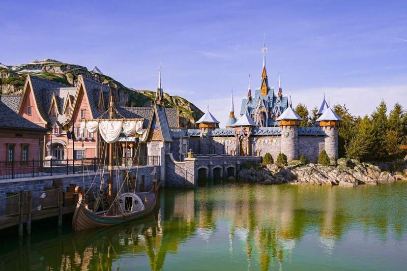 Colorful wooden buildings a castle and a docked Viking longship are meant to feel like  a visit to a coastal Norwegian town at Disneyland Paris World of Frozen.