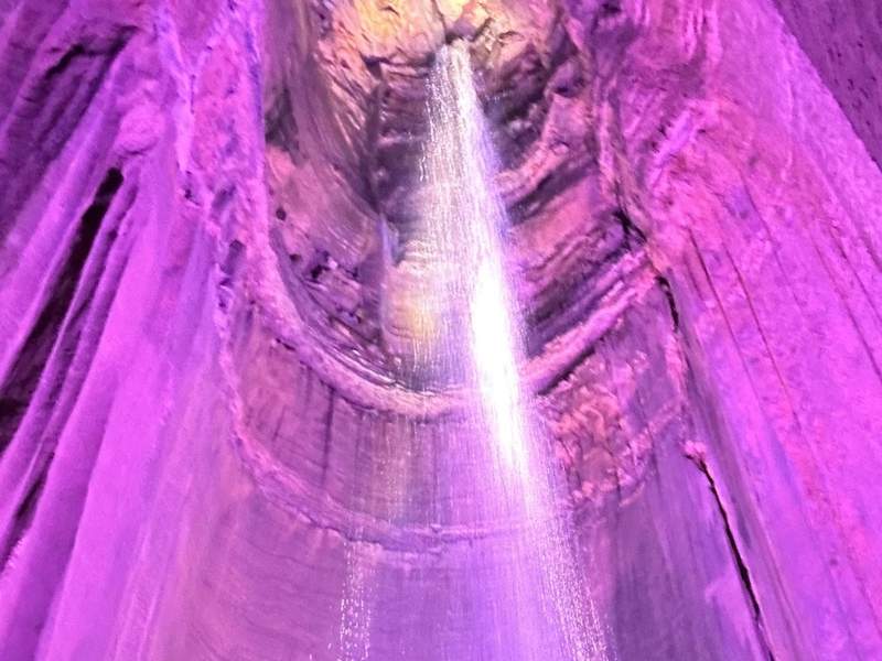 A waterfall with colored lights.