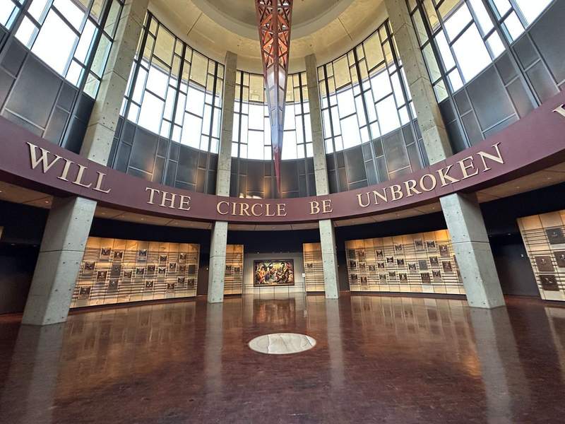 A circular room with photos around the sides of the room. 
