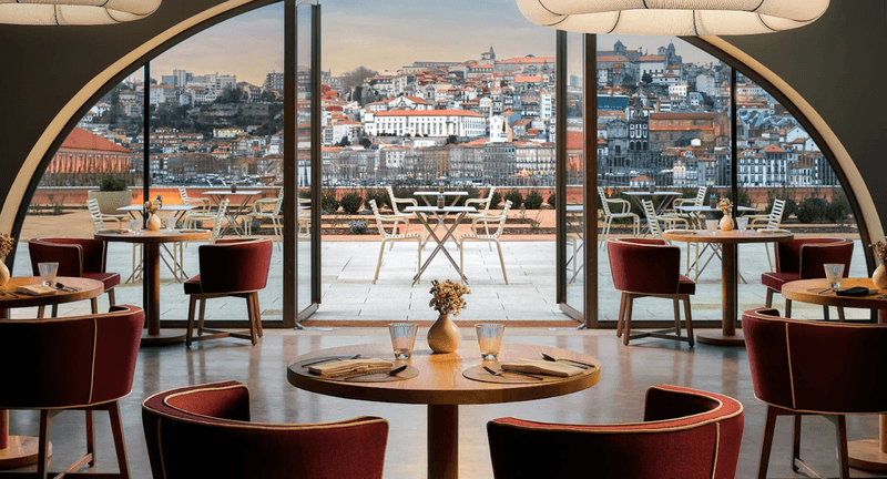 Indoor and outdoor seating at Boa Vista Terrace with dramatic views of Porto. 