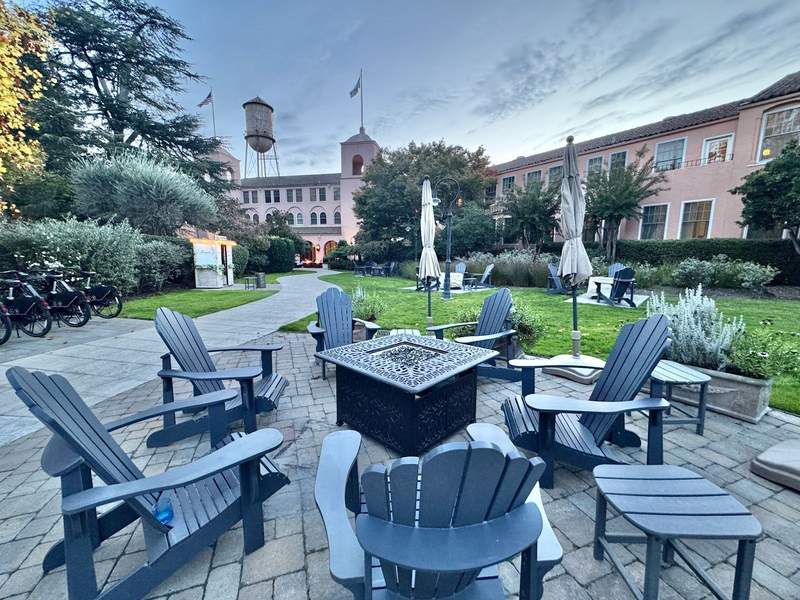 Huge firepit surrounded by Adirondack chairs along the walkway to the Fairmont Sonoma Mission Inn and Spa.