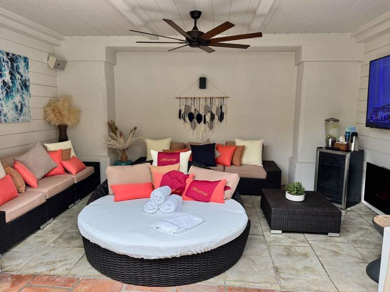 Poolside cabana with plenty of seating tv and fan at the Fairmont Sonoma Mission Inn  and Spa in CA.