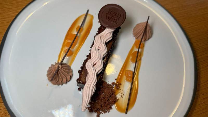 white plate topped with salted caramel melon cocoa dust meringue almond cocoa crisp from Charlotte at Lotte Hotel Seattle