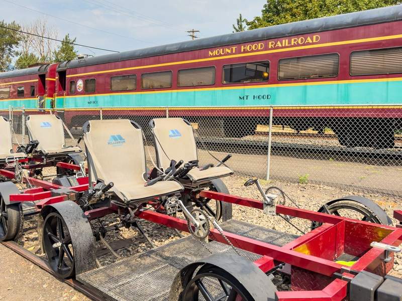 Mount Hood Railroad train car in the background and railbikes in the foreground.