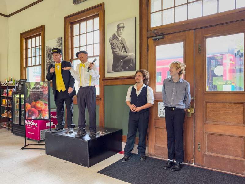 Inside the Mount Hood Railroad station watching the staff perform.
