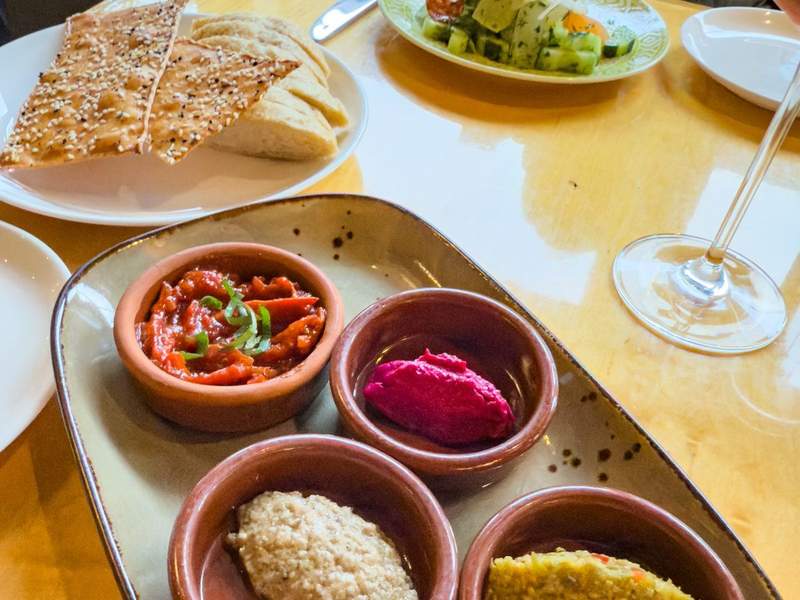 small plates and bowls of healthy snacks and breads