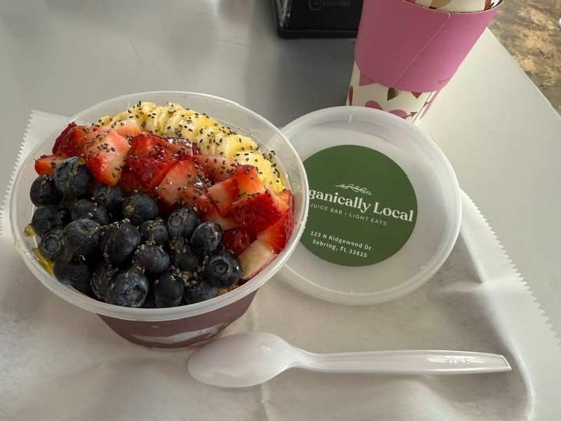 Healthy bowl with fruit on a table with a white spoon