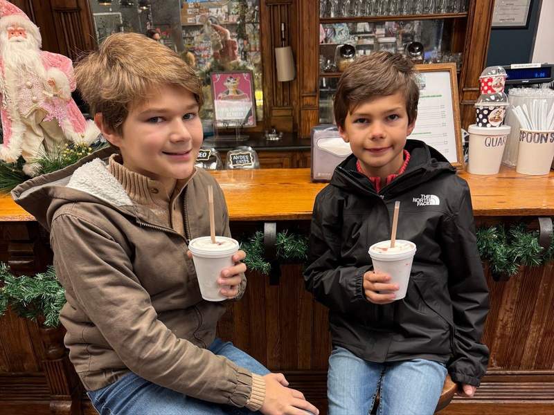 Two kids enjoy milkshakes at the Medicine Cabinet Soda Shoppe in LaGrange