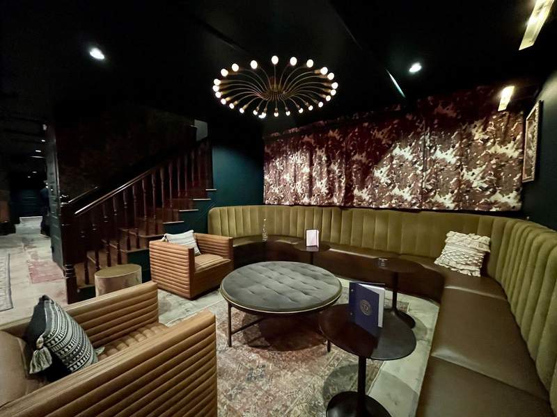 A lounge area inside the Dame bar with semi circular sofa and easy chairs. 