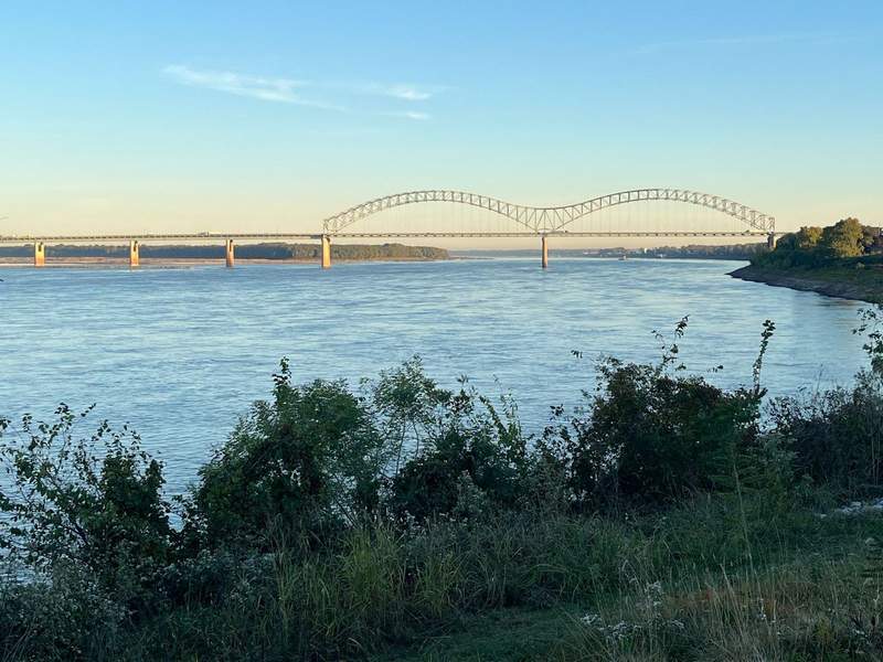 A view of the Mississippi River with a bridge in the background. 