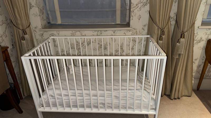 A white baby crib at The Stafford London. 