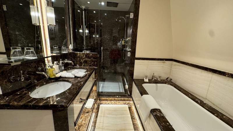 A marble bathroom with a marble bathtub in a Junior Suite at The Stafford London. 