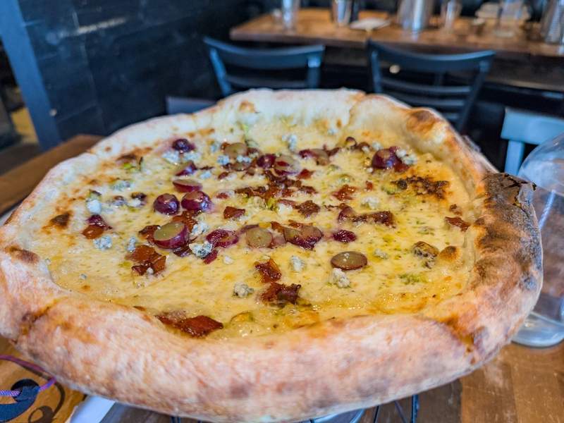 Close up of hot pizza delivered to the table.